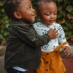 boy and girl surrounded by plants