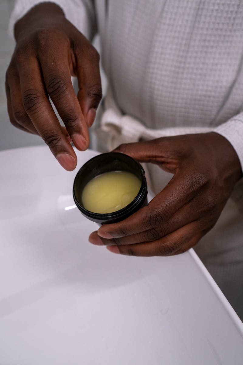 Close-up of hands holding a jar of cream, perfect for skincare or beauty content.