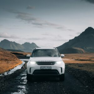 white nissan suv on brown field during daytime